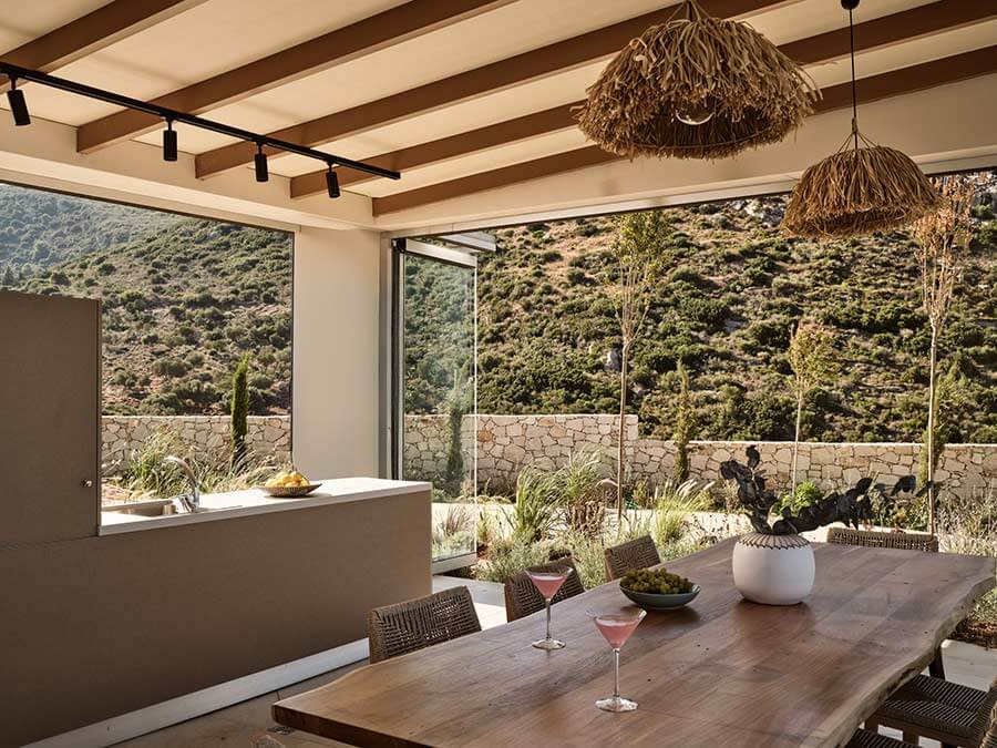 Covered terrace dining table with cocktails and olive tree views at Segreto Del Lusso