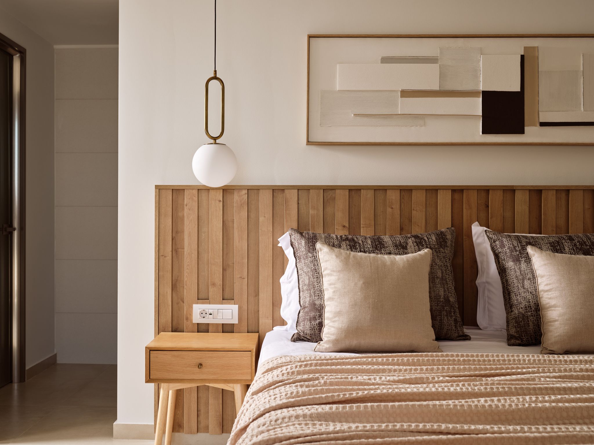 Luxury villa bedroom with wooden headboard in Zakynthos