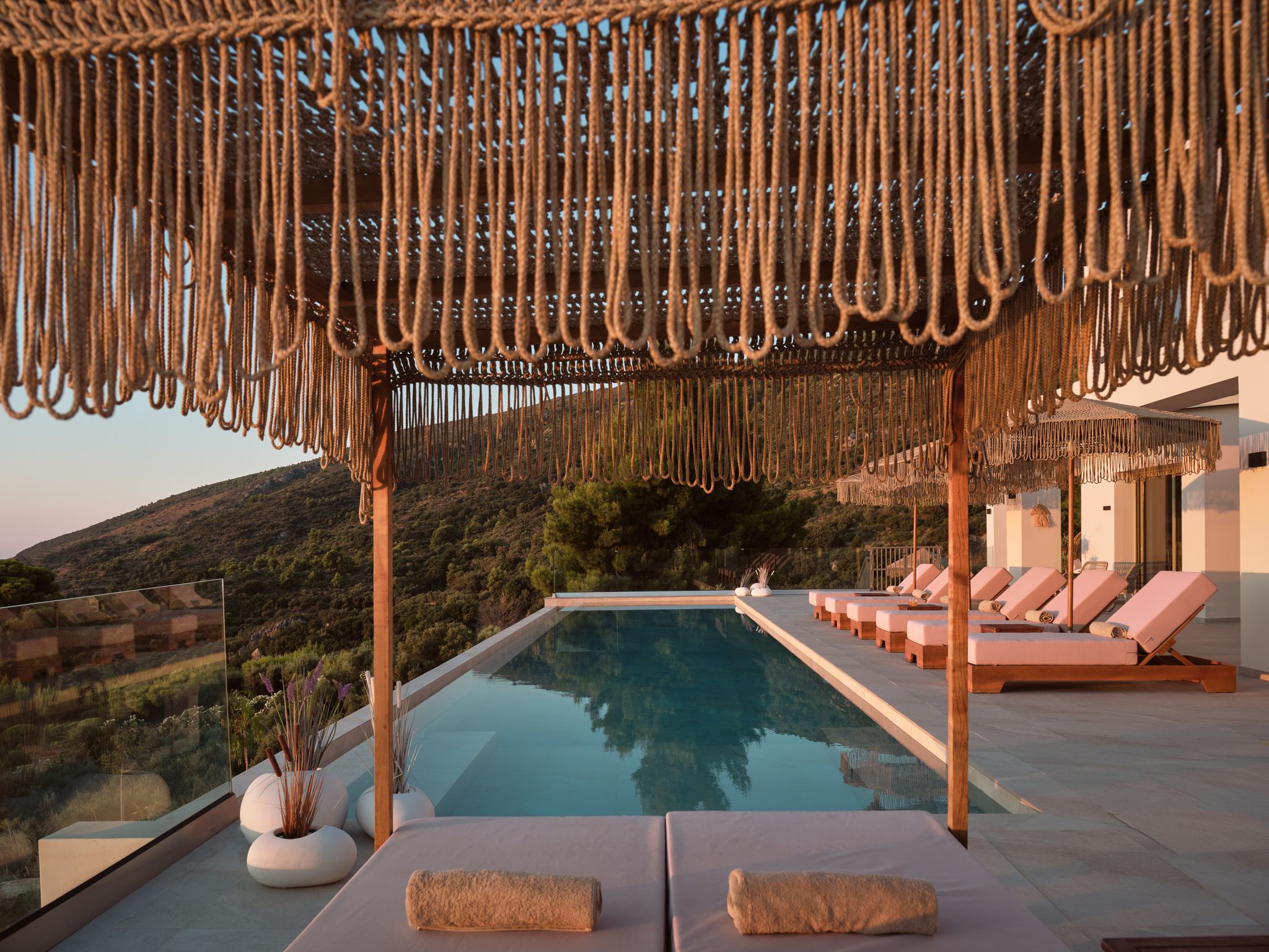 Pool terrace with rope pergola and sun loungers at Segreto Del Lusso