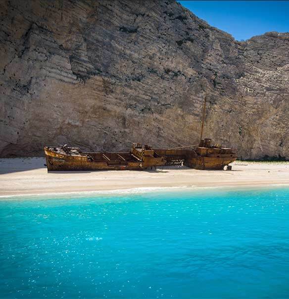 Navagio (Shipwreck) Beach with turquoise water and the wreck on white sand, Zakynthos
