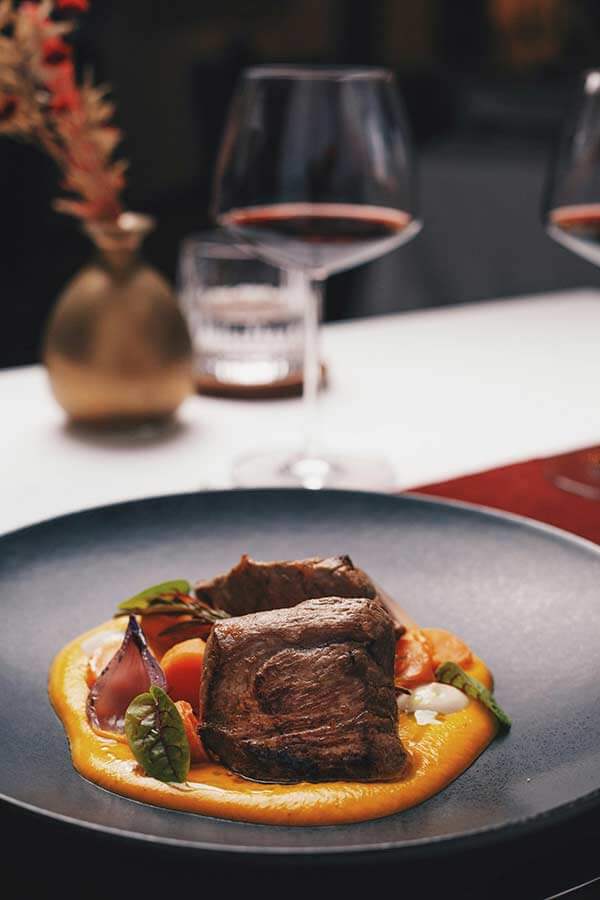 Steak with sauce and red wine, fine dining at Segreto Del Lusso villa