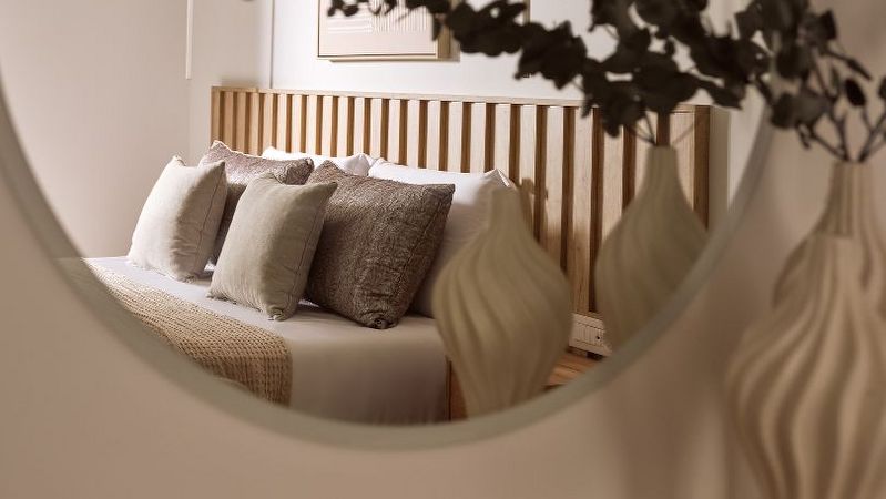 Bedroom reflected in round mirror – Segreto Del Lusso, Zakynthos